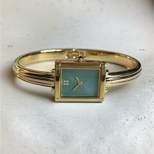 Yves Saint Laurent Gold Bangle Watch with Emerald Green Dial